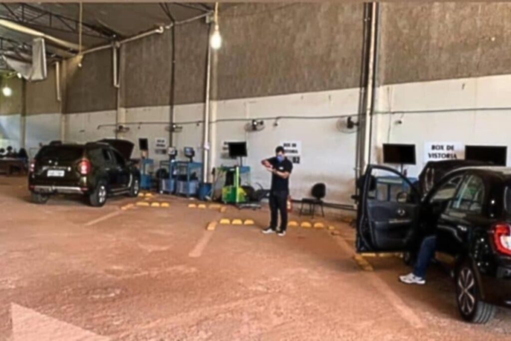 Parking area with cars and person checking phone.